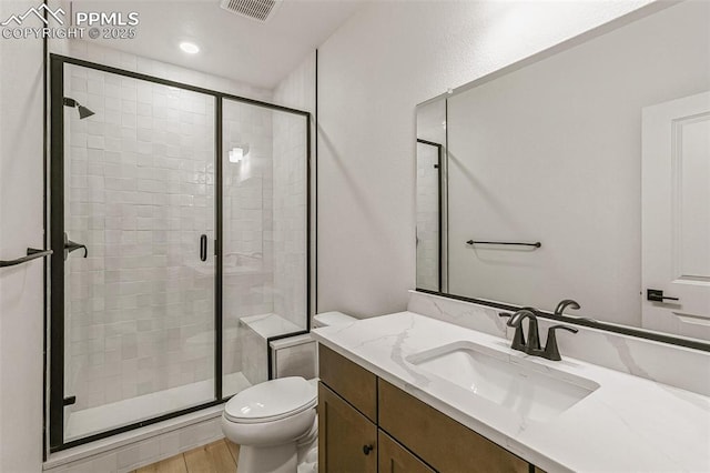 4331 Soapberry Pl, Castle Rock, CO 80108 - bathroom featuring a shower stall, vanity, visible vents, toilet, and wood finished floors