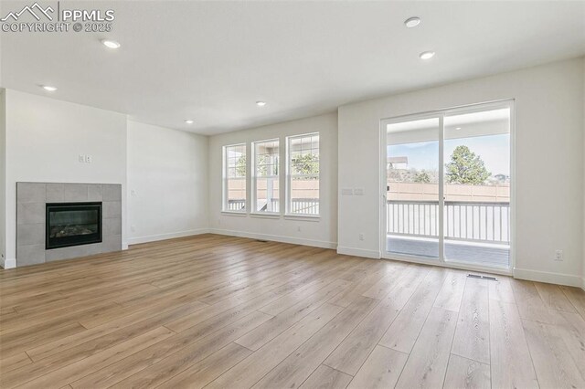 4331 Soapberry Pl, Castle Rock, CO 80108 - unfurnished living room featuring light wood finished floors, baseboards, recessed lighting, and a fireplace