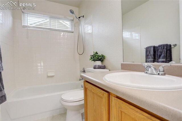 full bath featuring toilet, vanity, and  shower combination