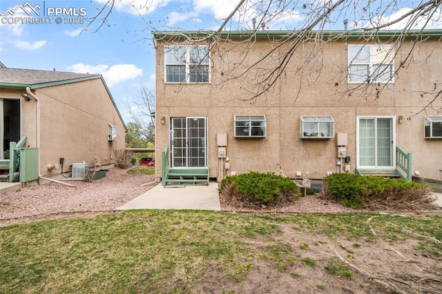 6142 Colony Cir, Colorado Springs, CO 80919 - back of property featuring stucco siding, entry steps, central AC, and a patio
