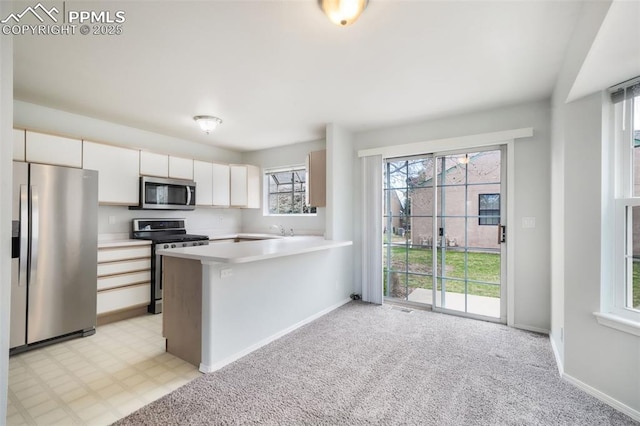 6142 Colony Cir, Colorado Springs, CO 80919 - kitchen featuring stainless steel appliances, light countertops, baseboards, and a peninsula