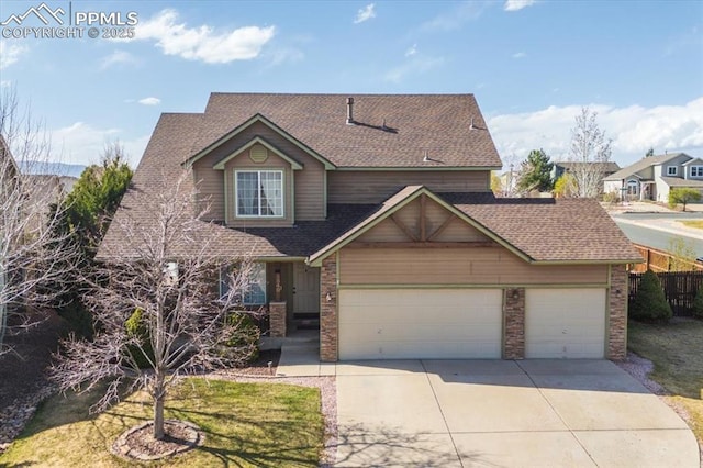 traditional-style house with driveway, stone siding, fence, a garage, and a shingled roof