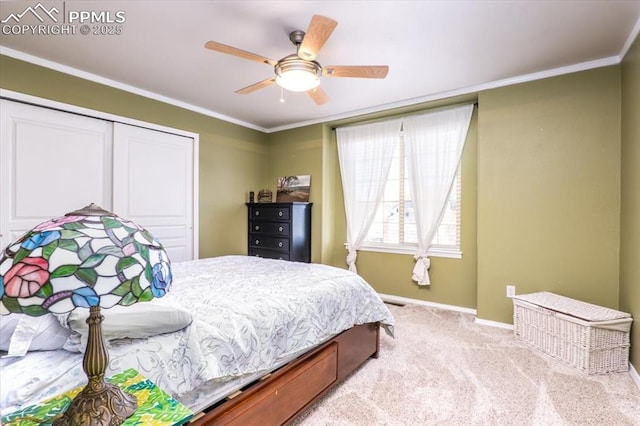bedroom featuring baseboards, a closet, ceiling fan, crown molding, and carpet floors