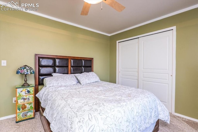 bedroom featuring carpet, a closet, baseboards, and ornamental molding