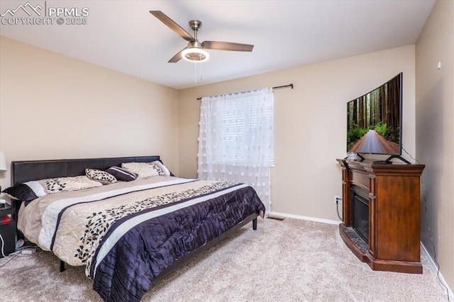 bedroom with a ceiling fan, baseboards, and carpet