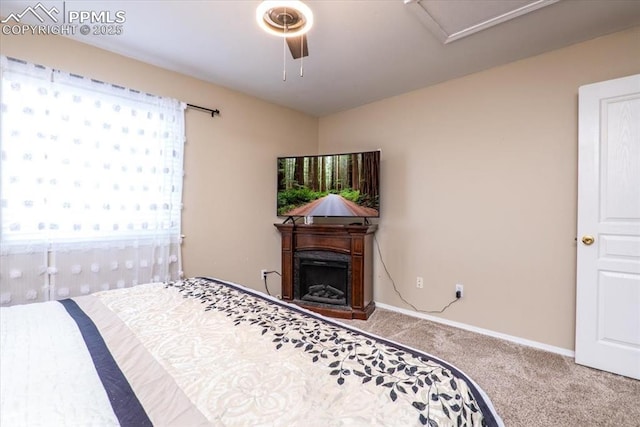 bedroom featuring a fireplace, carpet, baseboards, and ceiling fan
