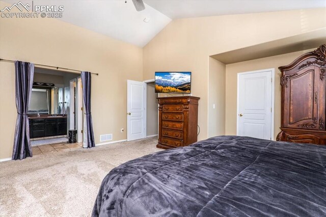 bedroom with high vaulted ceiling, ensuite bath, baseboards, carpet flooring, and visible vents