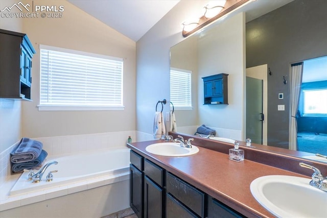 bathroom featuring a bath, vaulted ceiling, a shower stall, and a sink