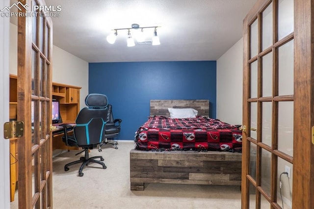 carpeted bedroom featuring french doors