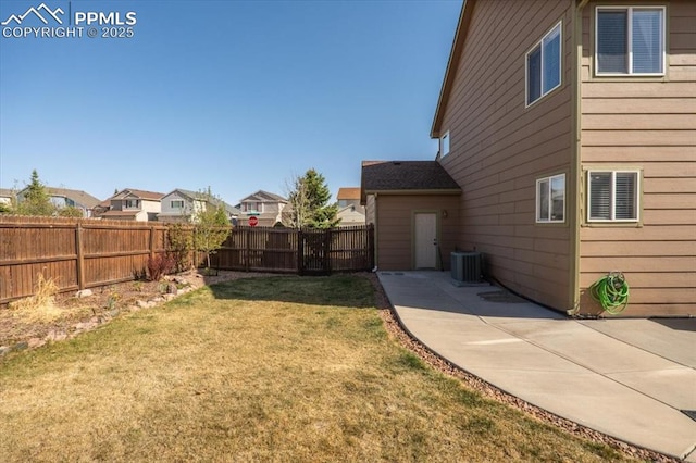 view of yard with a fenced backyard, a patio, a residential view, and cooling unit