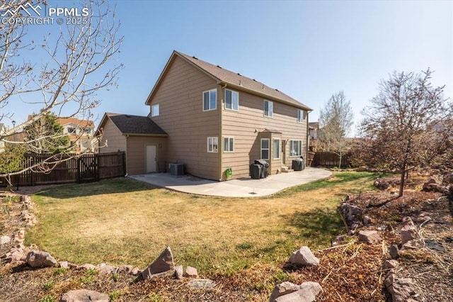 rear view of property featuring a patio area, a fenced backyard, a yard, and cooling unit