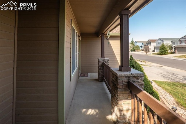 view of side of home featuring a porch and a residential view
