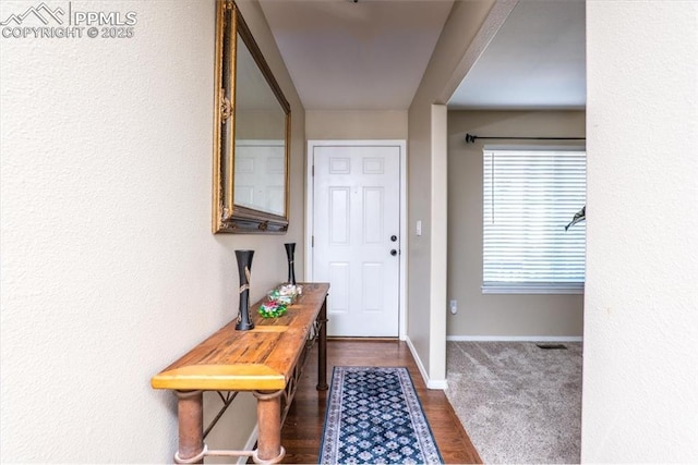 interior space with baseboards and dark wood-style floors