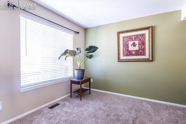 sitting room featuring carpet, visible vents, baseboards, and a healthy amount of sunlight