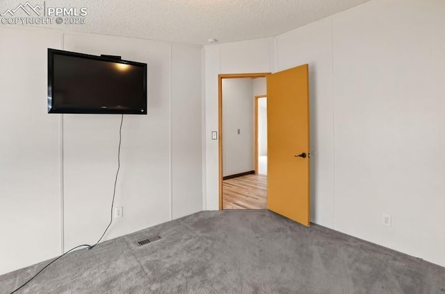 interior space with a textured ceiling and visible vents