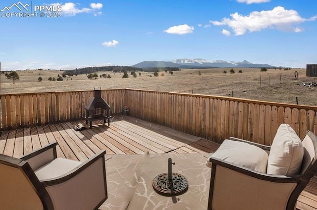 exterior space with a rural view and a deck with mountain view