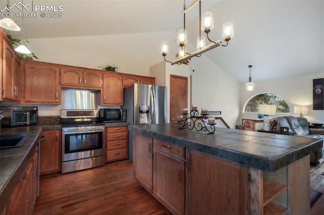 kitchen with dark countertops, high vaulted ceiling, appliances with stainless steel finishes, and dark wood finished floors