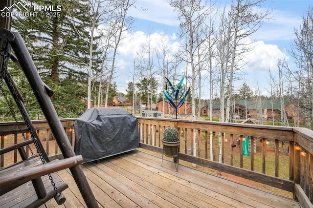 wooden terrace featuring a residential view and area for grilling