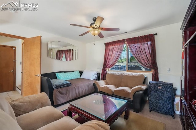 living area featuring carpet flooring and ceiling fan