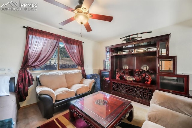 living area featuring a ceiling fan and visible vents