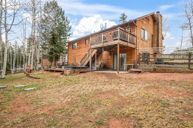 back of house with a chimney, stairway, fence, and a deck