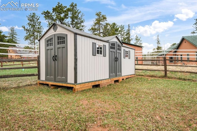 view of shed with a fenced backyard
