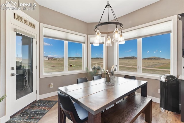 20356 Royal Troon Dr, Monument, CO 80132 - dining space with plenty of natural light, a chandelier, and wood finished floors