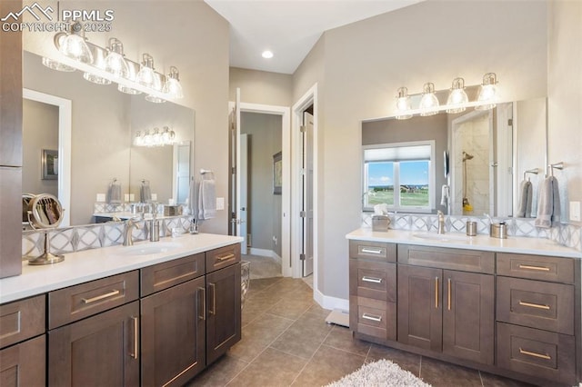 20356 Royal Troon Dr, Monument, CO 80132 - bathroom featuring two vanities, tile patterned flooring, a stall shower, baseboards, and recessed lighting