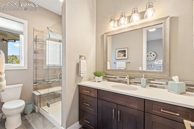 20356 Royal Troon Dr, Monument, CO 80132 - full bath with vanity, backsplash, toilet, a stall shower, and baseboards