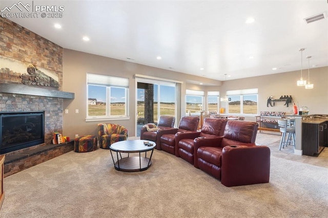 20356 Royal Troon Dr, Monument, CO 80132 - living room featuring a stone fireplace, light carpet, and recessed lighting