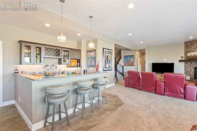 20356 Royal Troon Dr, Monument, CO 80132 - kitchen with recessed lighting, a kitchen breakfast bar, a peninsula, baseboards, and pendant lighting