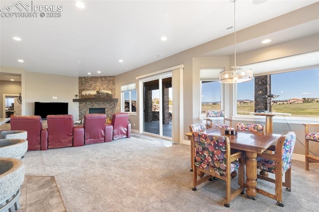 20356 Royal Troon Dr, Monument, CO 80132 - dining area featuring a fireplace, recessed lighting, carpet flooring, and a chandelier