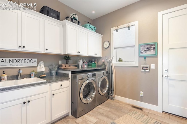 20356 Royal Troon Dr, Monument, CO 80132 - laundry room with washing machine and dryer, light wood-style floors, baseboards, and cabinet space