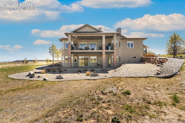 20356 Royal Troon Dr, Monument, CO 80132 - back of property with a balcony, a patio, stucco siding, a chimney, and a yard
