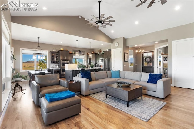 20356 Royal Troon Dr, Monument, CO 80132 - living room featuring a chandelier, ceiling fan, high vaulted ceiling, light wood-style floors, and recessed lighting