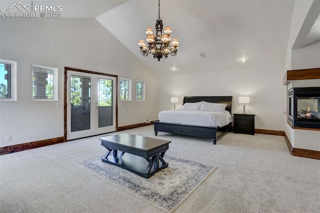 bedroom featuring access to outside, baseboards, an inviting chandelier, carpet flooring, and high vaulted ceiling