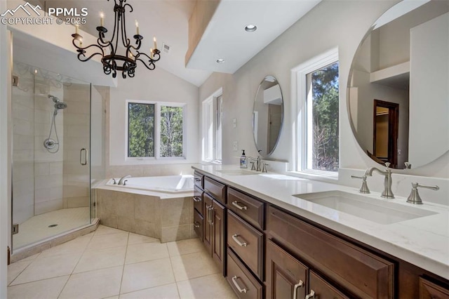 bathroom with plenty of natural light, a garden tub, and a sink