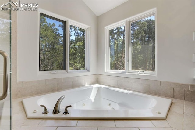full bathroom with a tub with jets and lofted ceiling