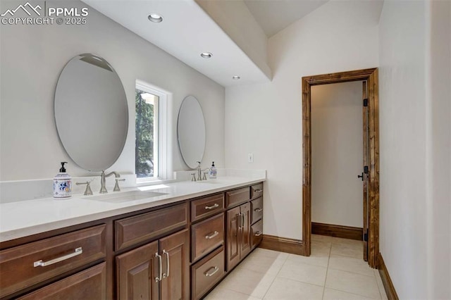 full bathroom featuring baseboards, double vanity, recessed lighting, tile patterned floors, and a sink