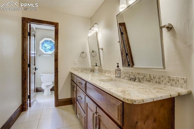 full bath featuring tile patterned flooring, toilet, a sink, double vanity, and baseboards