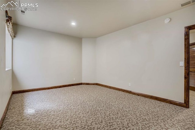 unfurnished room with recessed lighting, visible vents, and baseboards