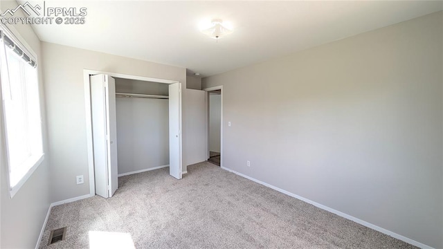 720 W Northwoods Dr, Woodland Park, CO 80863 - unfurnished bedroom with baseboards, a closet, visible vents, and carpet