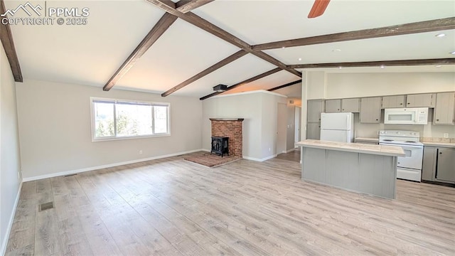 720 W Northwoods Dr, Woodland Park, CO 80863 - kitchen featuring a center island, open floor plan, vaulted ceiling with beams, gray cabinetry, and white appliances