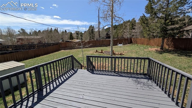 720 W Northwoods Dr, Woodland Park, CO 80863 - wooden terrace with a lawn and a fenced backyard