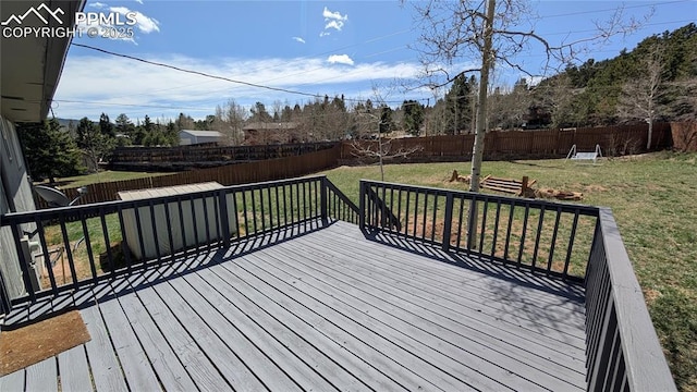 720 W Northwoods Dr, Woodland Park, CO 80863 - wooden deck with a lawn and a fenced backyard