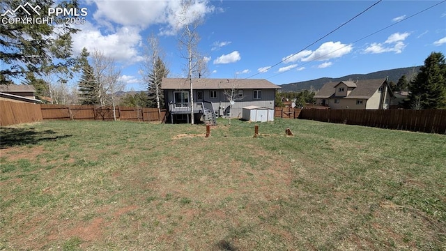 720 W Northwoods Dr, Woodland Park, CO 80863 - view of yard featuring a fenced backyard, an outdoor structure, stairs, and a storage shed