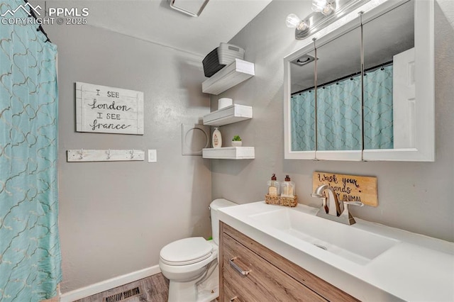 6465 Pawnee Cir, Colorado Springs, CO 80915 - full bathroom with visible vents, wood finished floors, vanity, baseboards, and toilet
