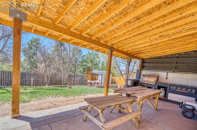 6465 Pawnee Cir, Colorado Springs, CO 80915 - view of patio featuring a fenced backyard, a shed, an outbuilding, and area for grilling