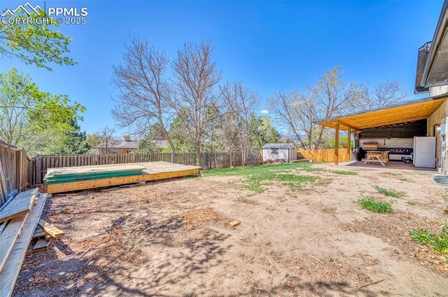 6465 Pawnee Cir, Colorado Springs, CO 80915 - view of yard featuring an outbuilding, a wooden deck, a fenced backyard, and a shed