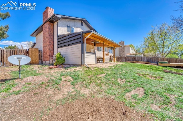 6465 Pawnee Cir, Colorado Springs, CO 80915 - rear view of house featuring a chimney and a fenced backyard